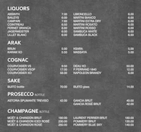 a black and white menu with prices on it